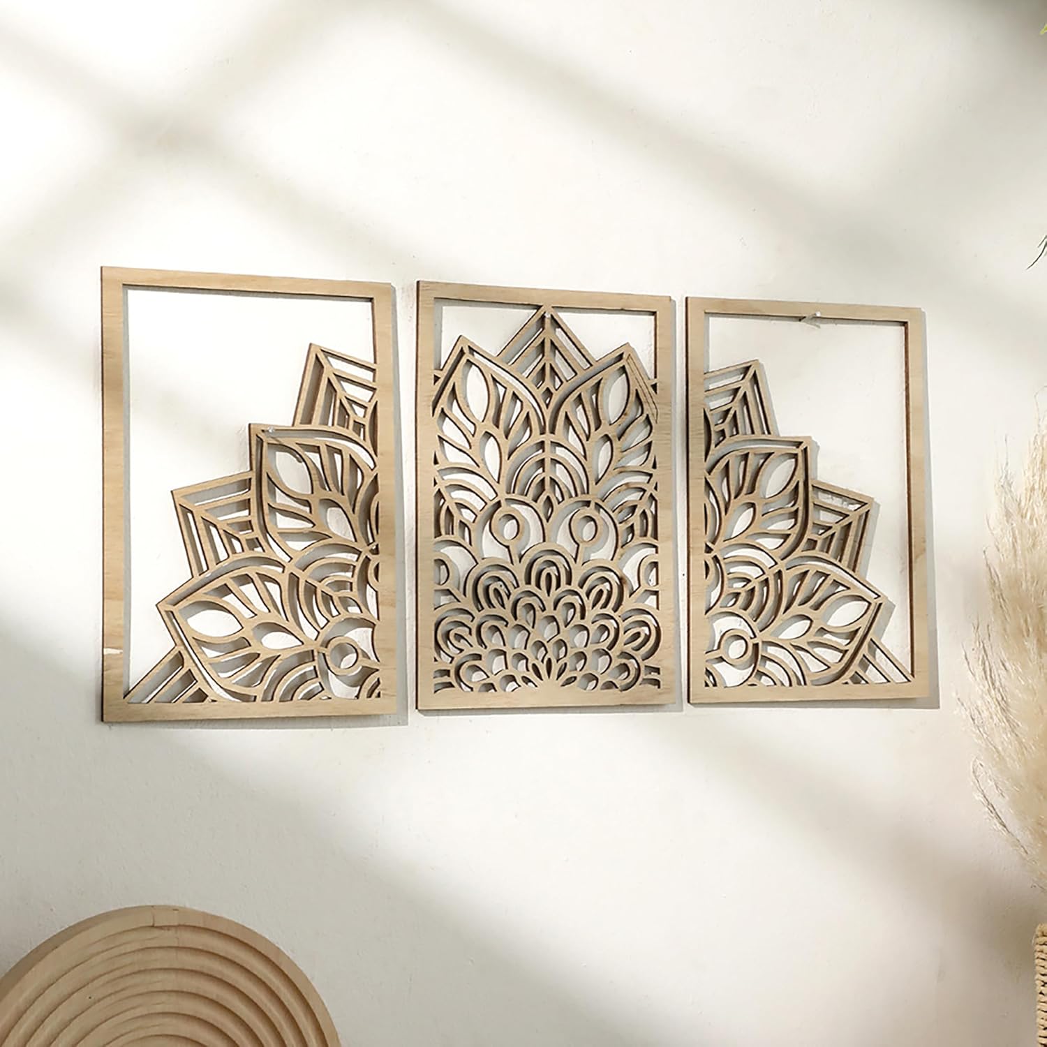 Decorative wall art with geometric patterns in wooden frames on a light background