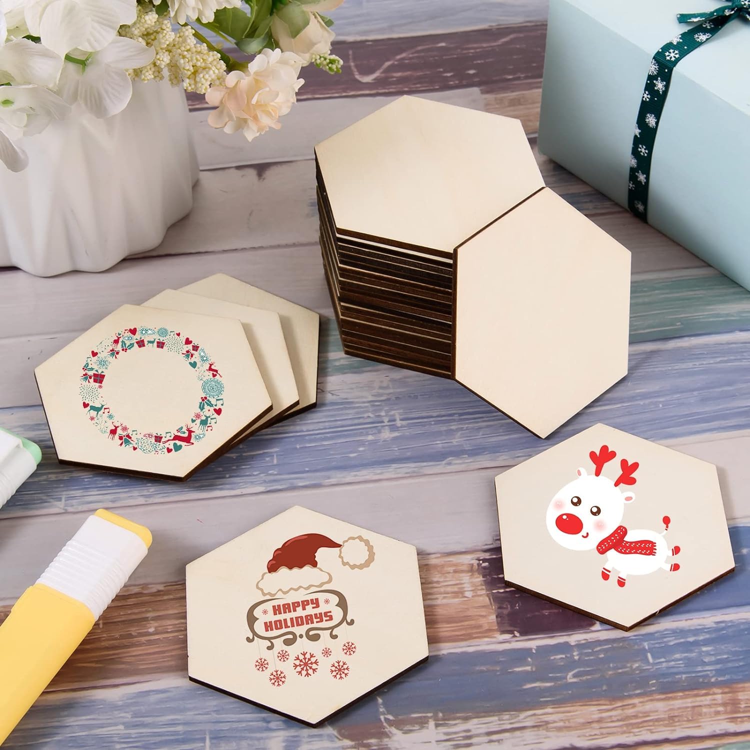 Hexagonal wooden coasters with Christmas designs on a wooden surface.