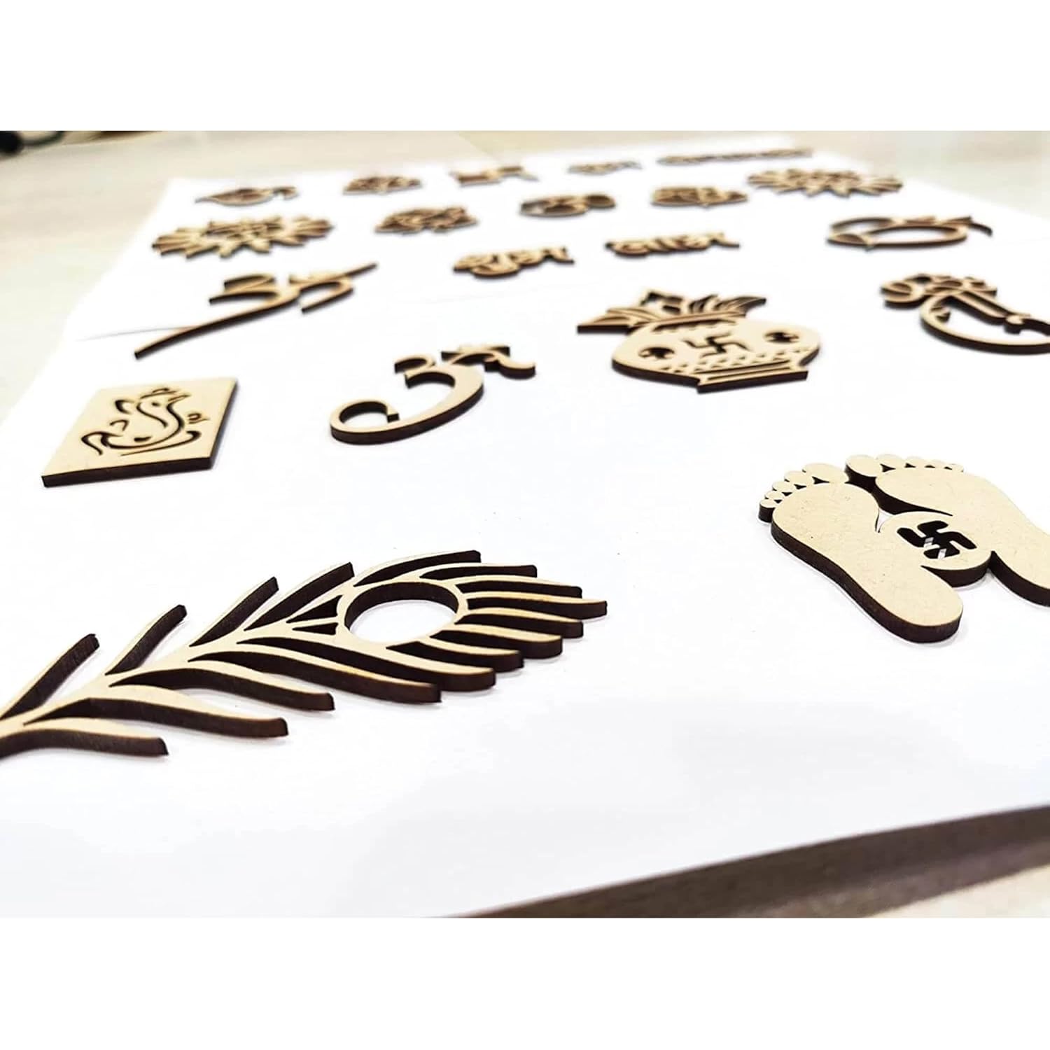 Wooden cutouts of various shapes and designs on a white surface