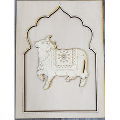 Decorative wall art with a cow design in a decorative frame on a white background