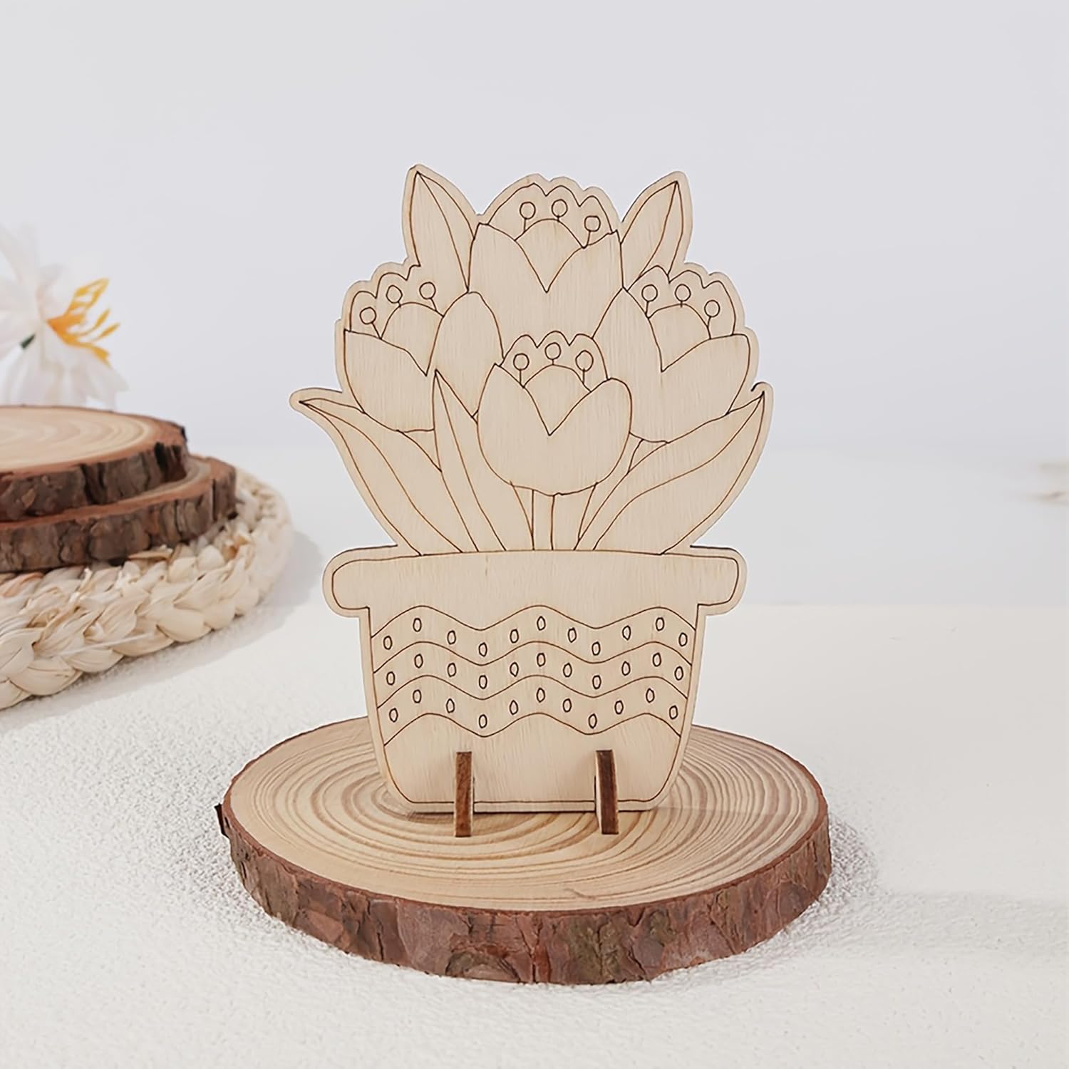 Wooden decorative piece of a potted plant on a wooden stand with a white background