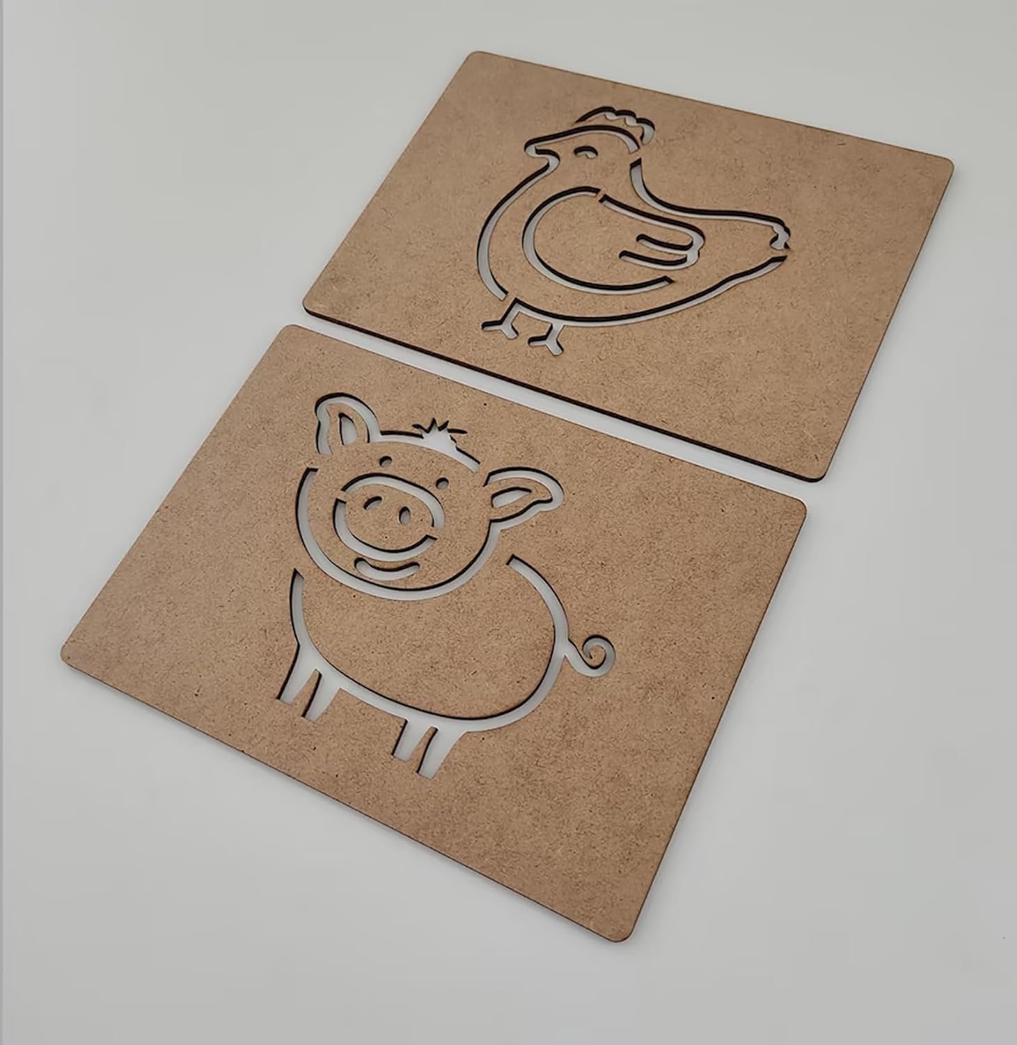 Two cardboard cutouts of a chicken and a pig on a light gray background
