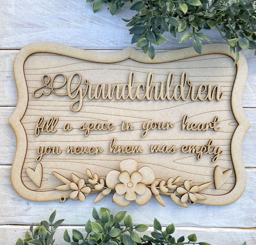 Decorative wooden sign with floral designs and text on a light wood background