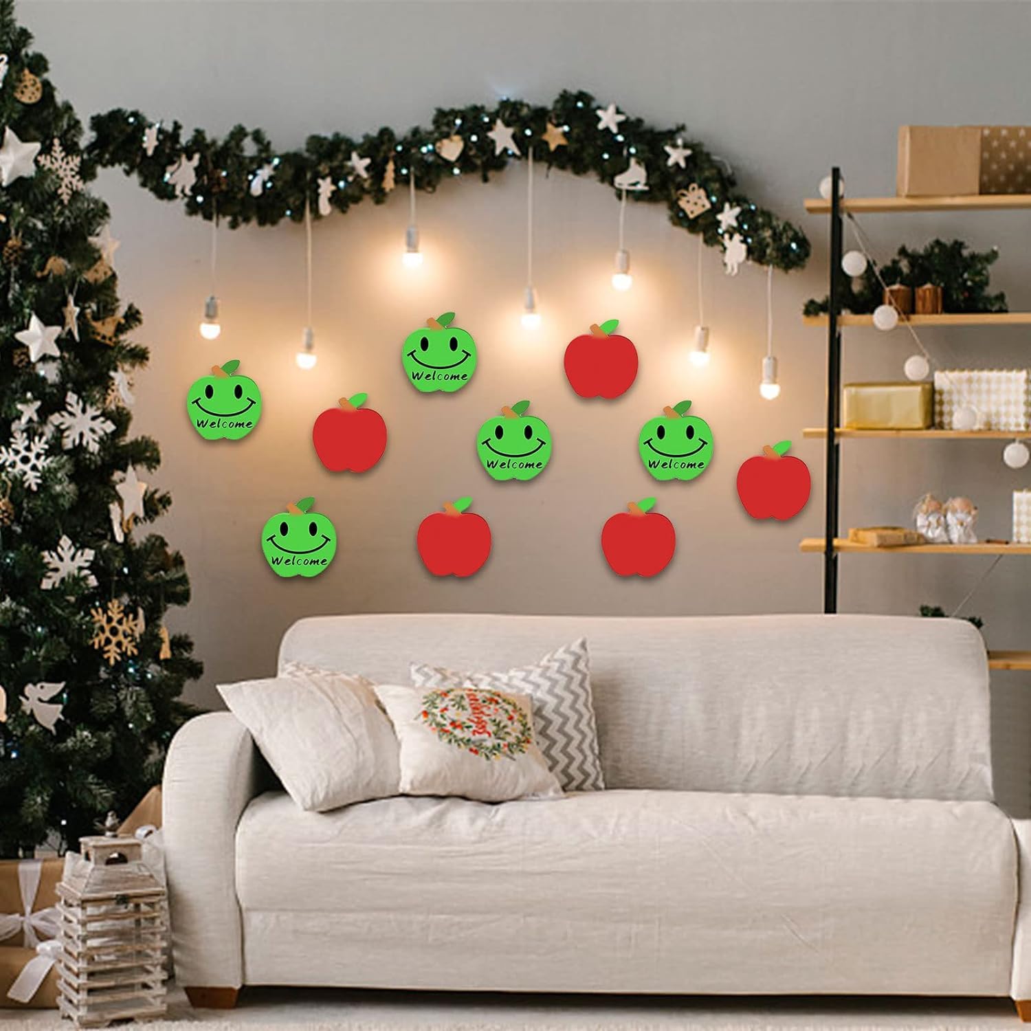 Decorative wall art with smiling apples and green leaves in a living room setting.