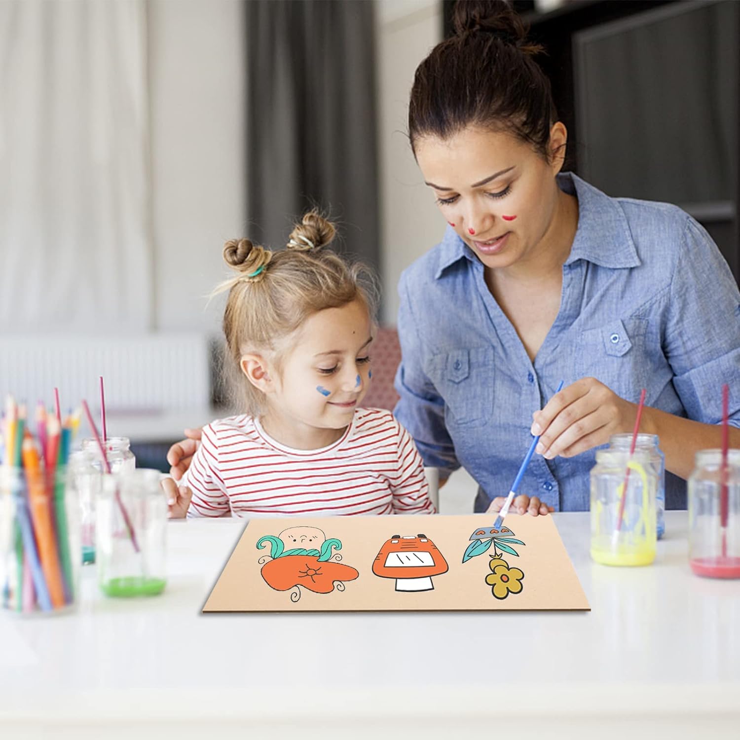 Woman and child painting on a paper with colorful markers