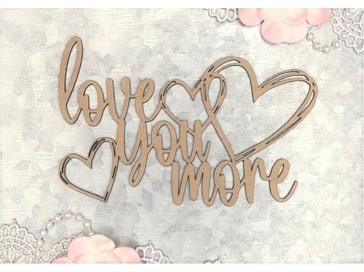 Decorative wooden sign with 'love you more' text on a soft background