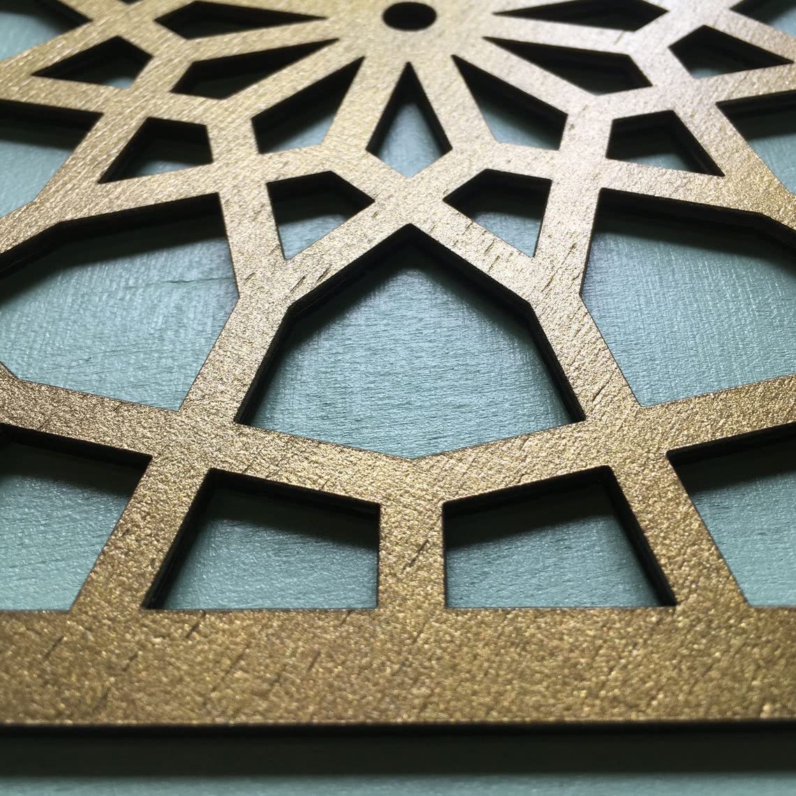 Metallic decorative panel with geometric pattern on a blue background