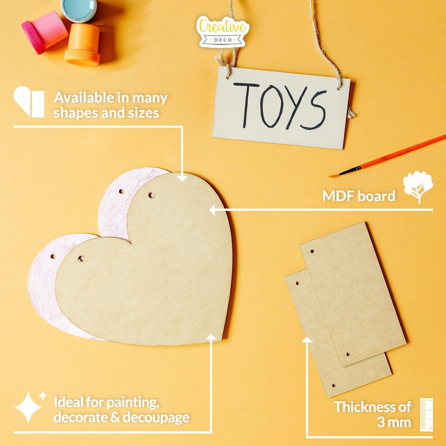 Heart-shaped MDF board with paint cans, a brush, and text on a yellow background