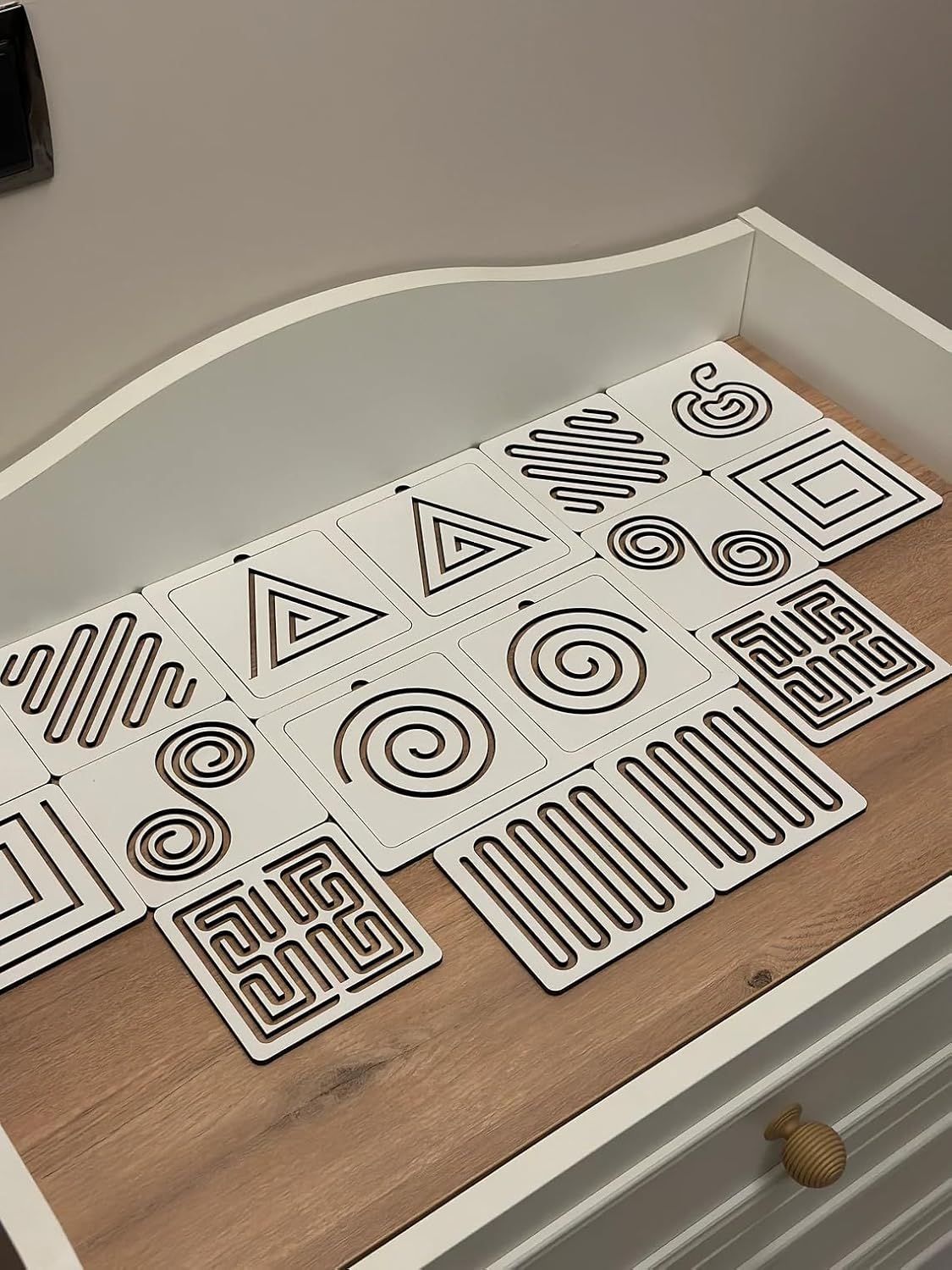 Set of geometric patterned coasters on a wooden surface