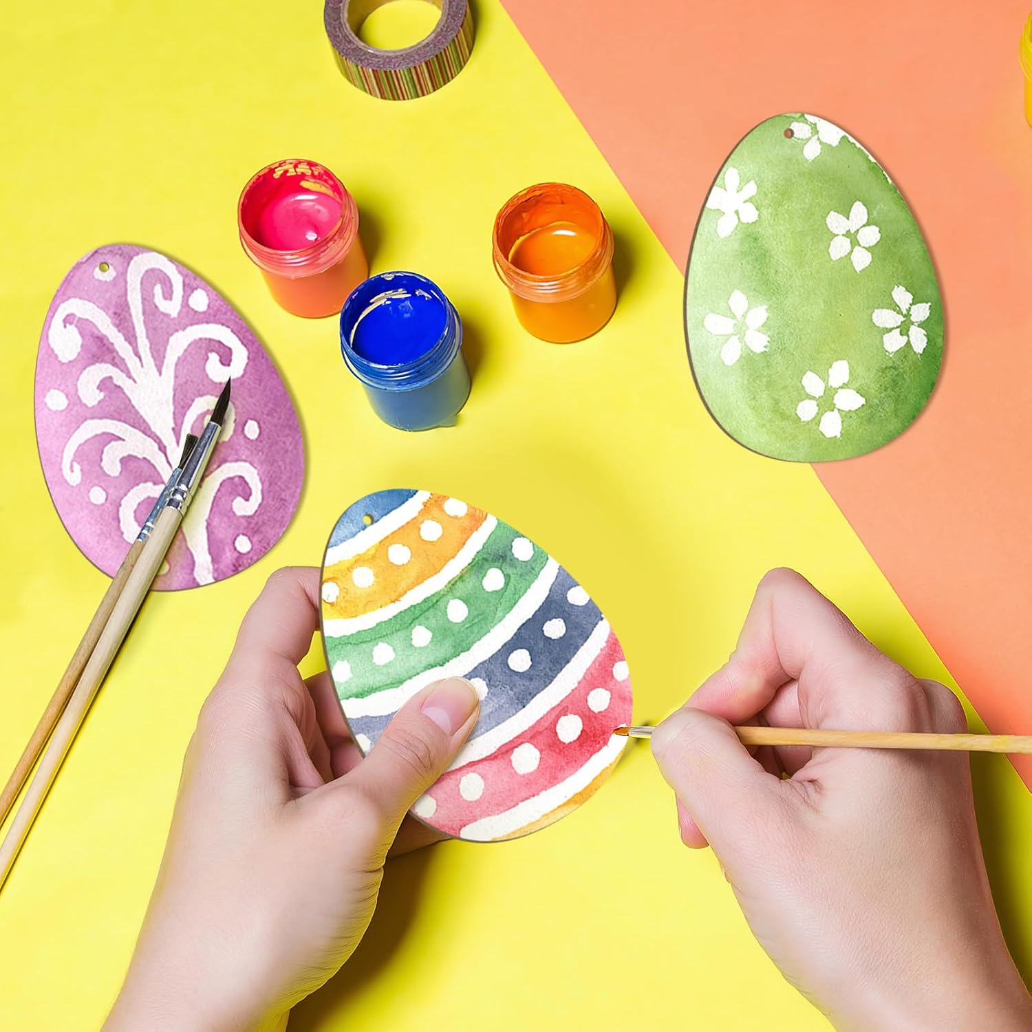 Colorful Easter egg painting activity on a yellow and orange background