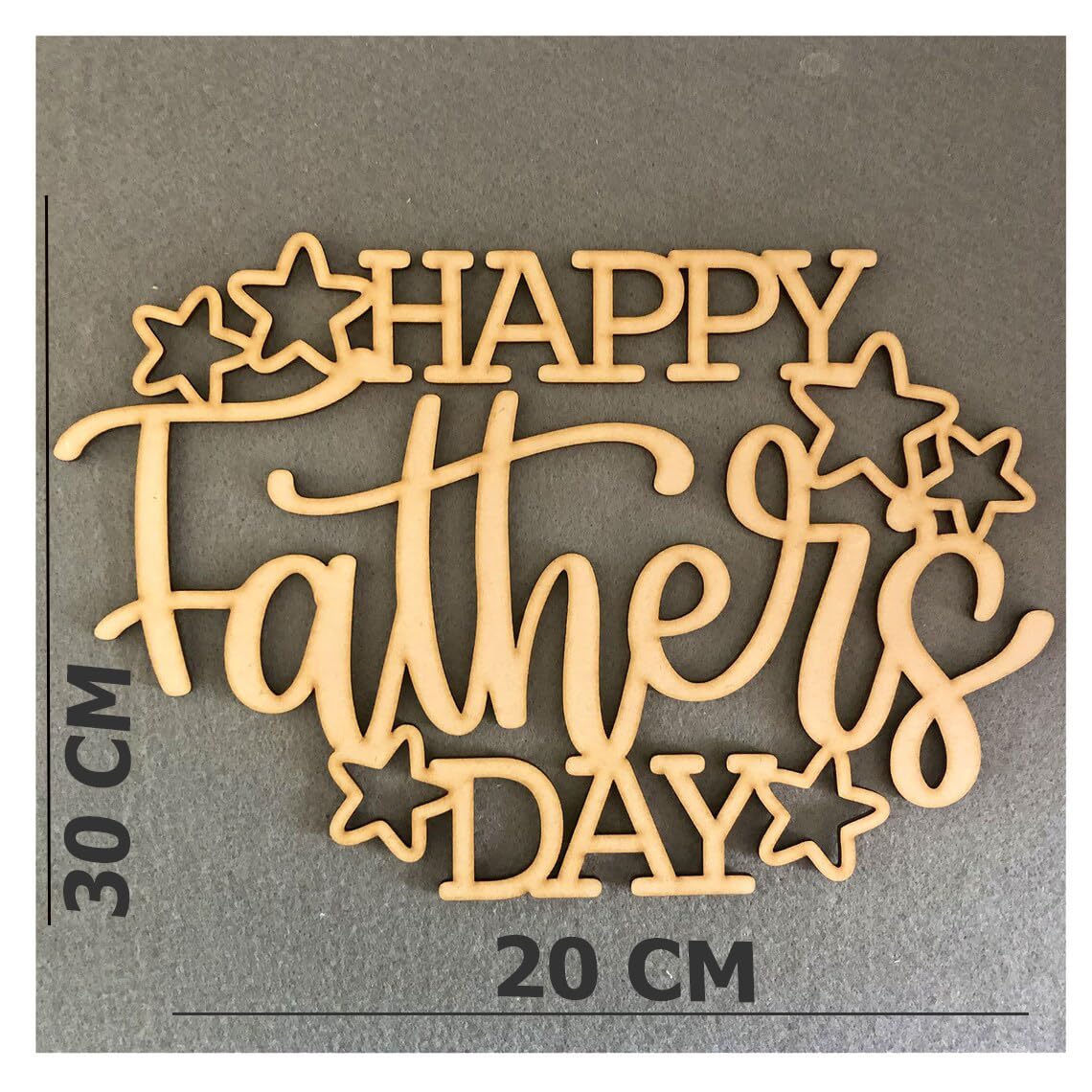 Wooden cutout with 'Happy Father's Day' text on a gray background