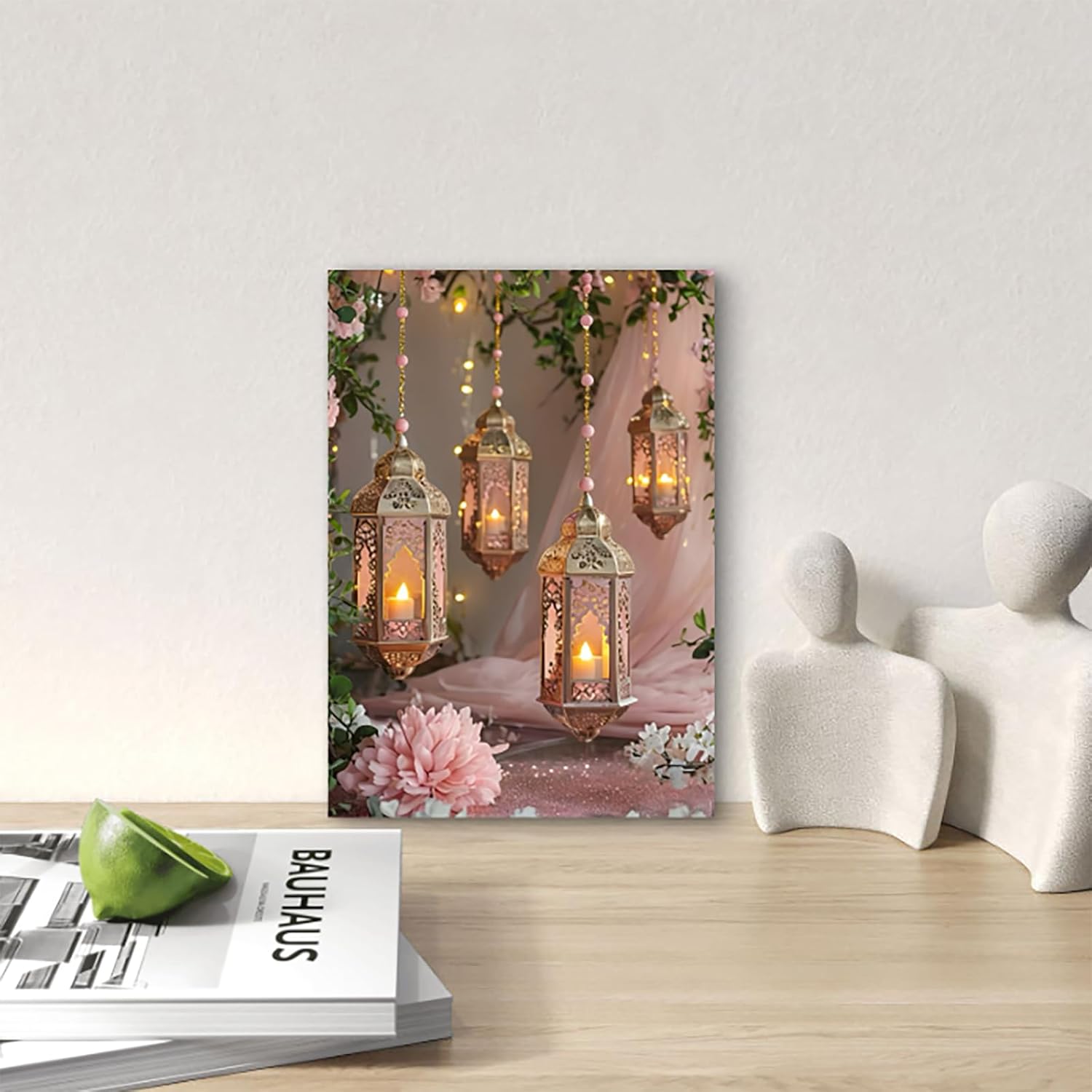 Decorative wall art with hanging lanterns and flowers on a wooden surface.