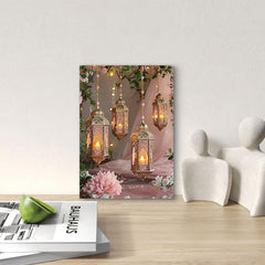 Decorative wall art with hanging lanterns and flowers on a wooden surface.