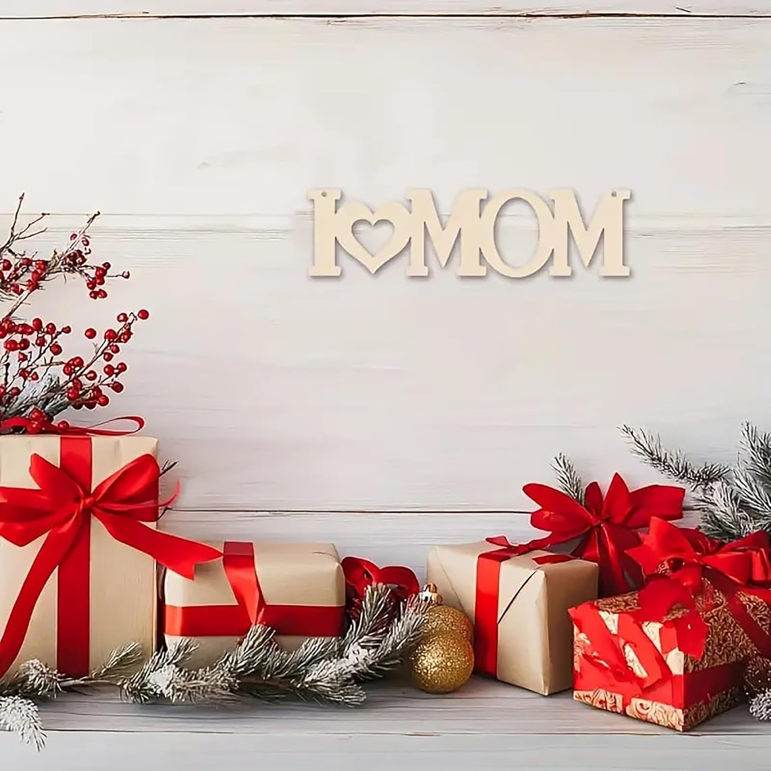 Gifts with red ribbons and a 'I love Mom' sign on a wooden background
