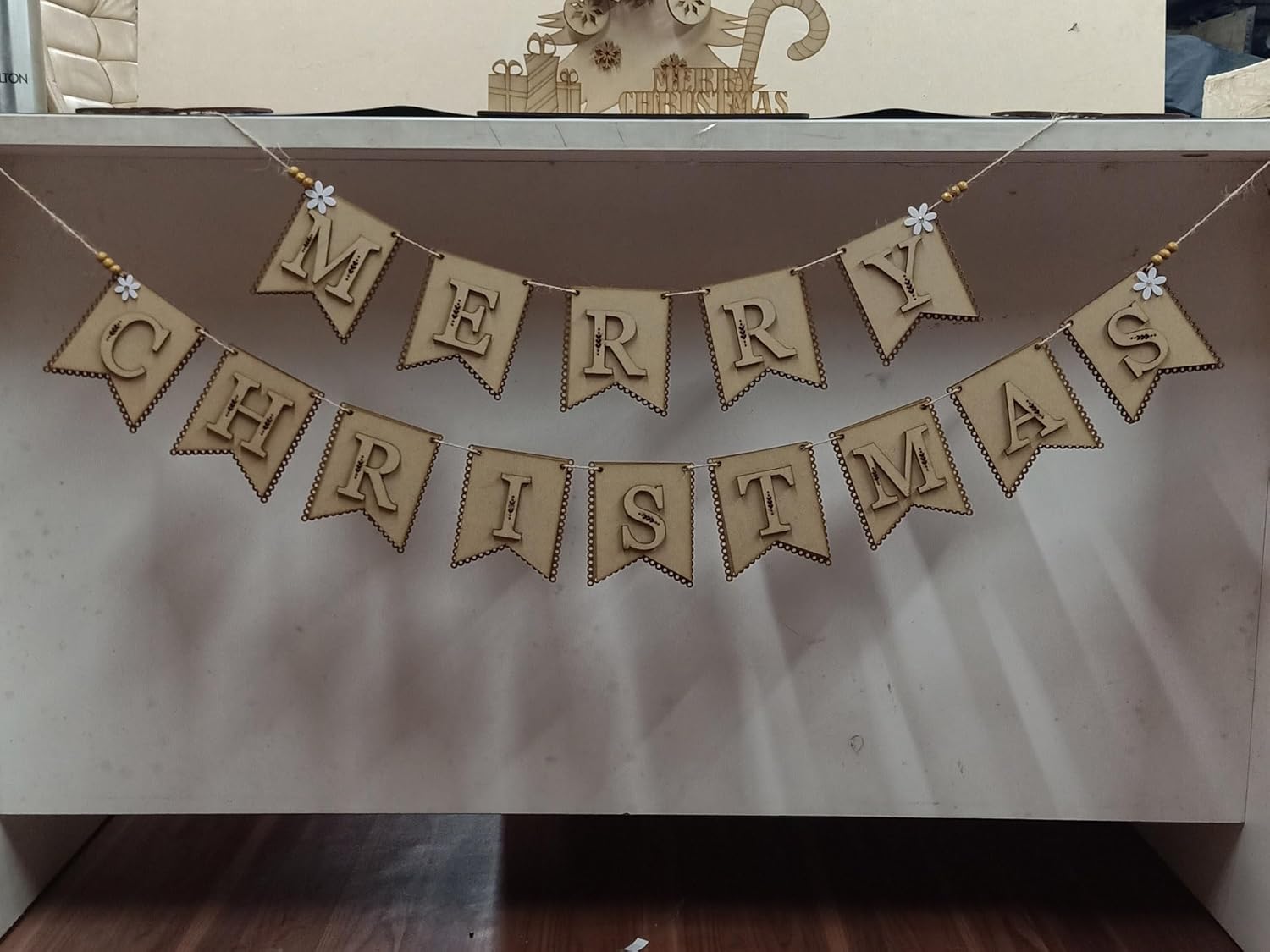 Merry Christmas banner made of wooden flags on a plain background
