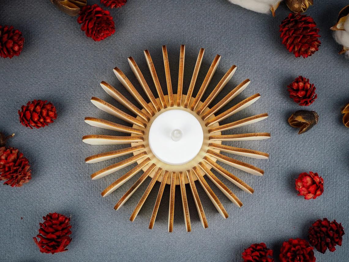 Decorative candle holder with red pinecones on a gray background