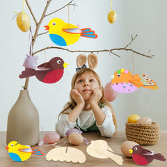Child with Easter decorations including birds and eggs on a table.