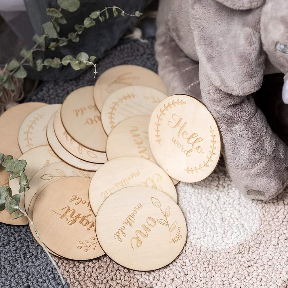 Round wooden coasters with engraved text on a textured surface with a plush toy and plant in the background.