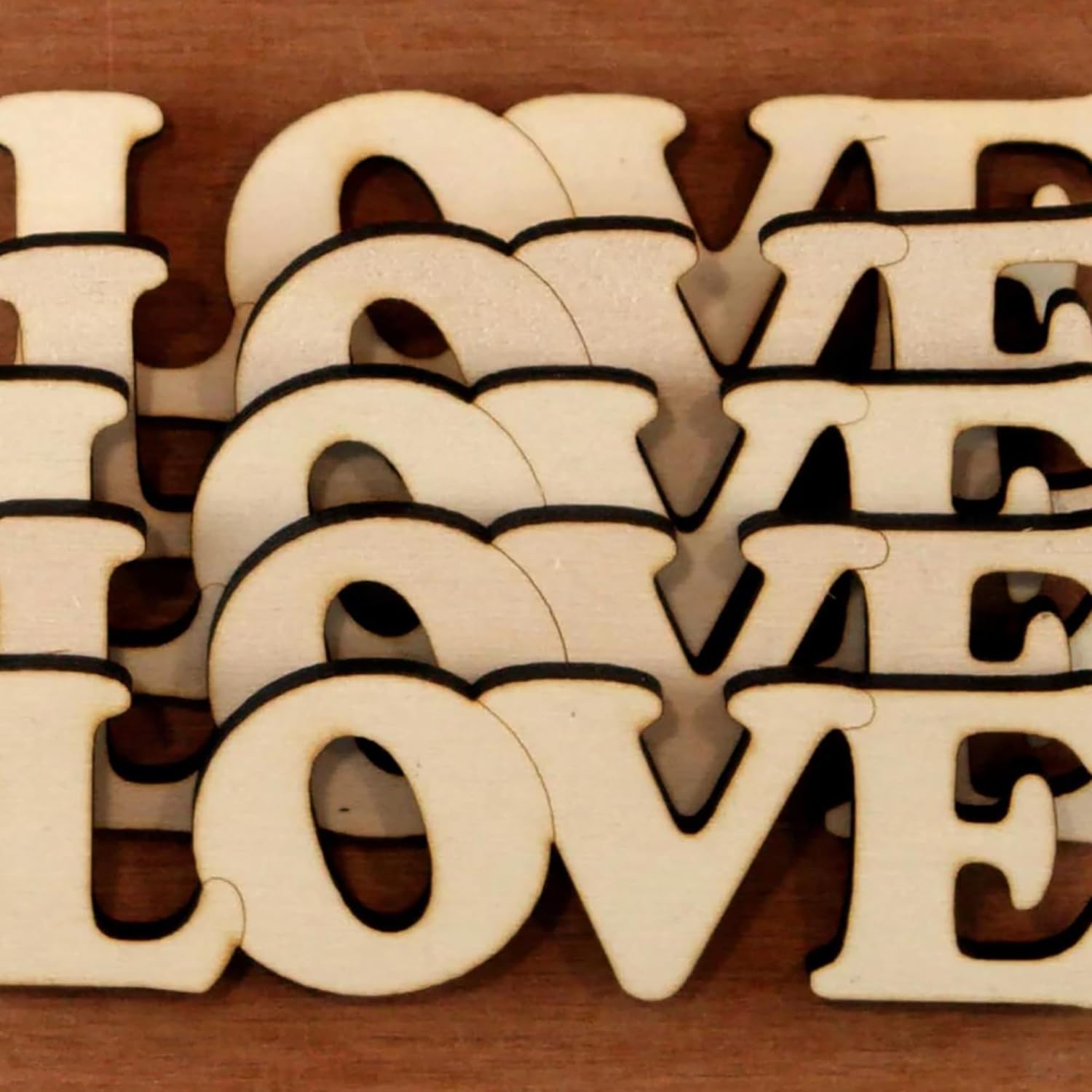 Wooden letters spelling 'LOVE' on a wooden background
