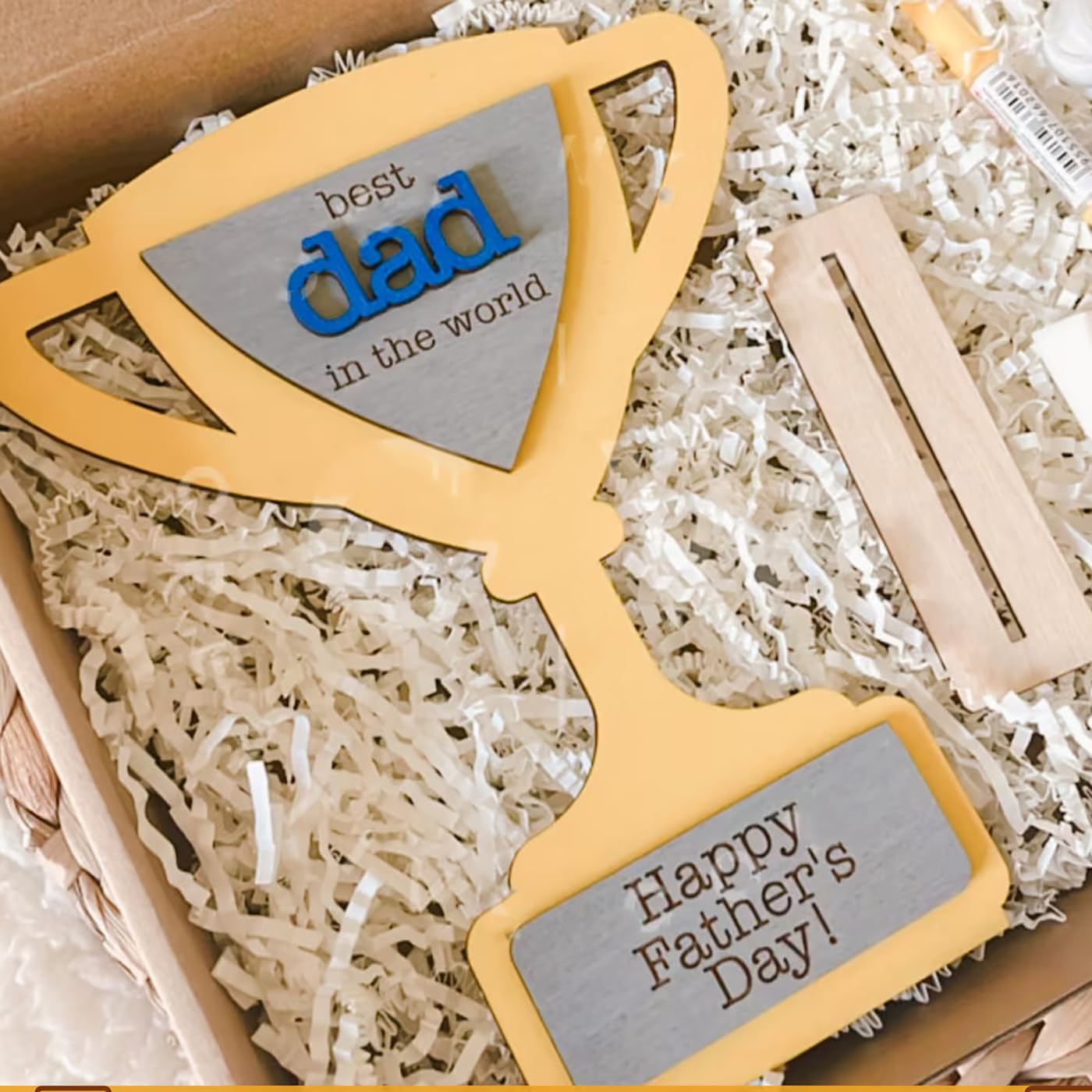 Decorative glasses with 'best dad in the world' and 'Happy Father's Day!' engraved on a crinkled paper background.