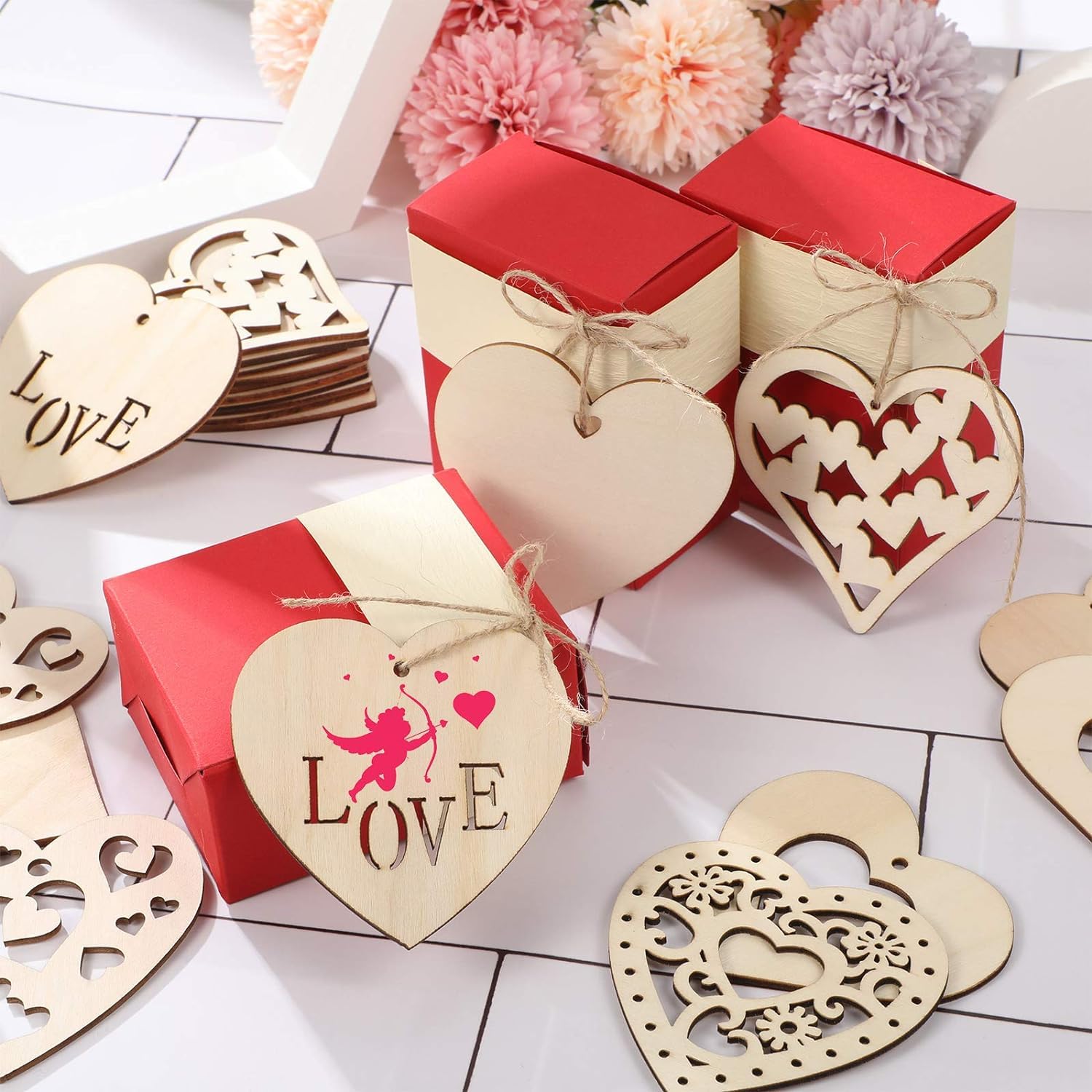 Heart-shaped wooden decorations with 'LOVE' and floral elements on a white surface