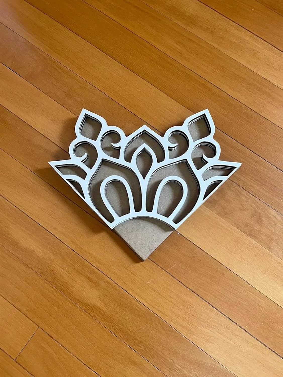 Decorative metal grille on a wooden floor
