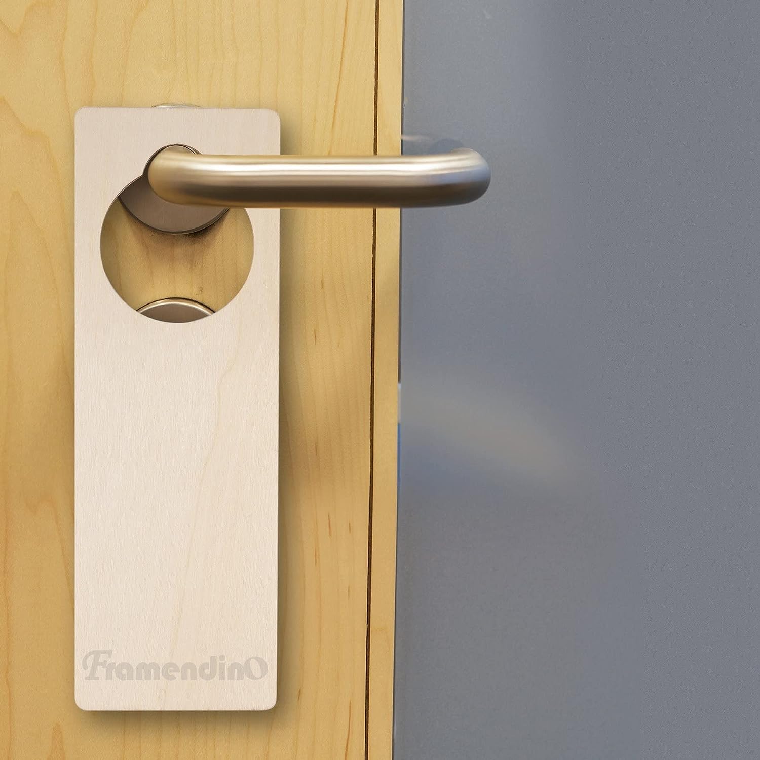 Door handle on a wooden door with a blurred gray background