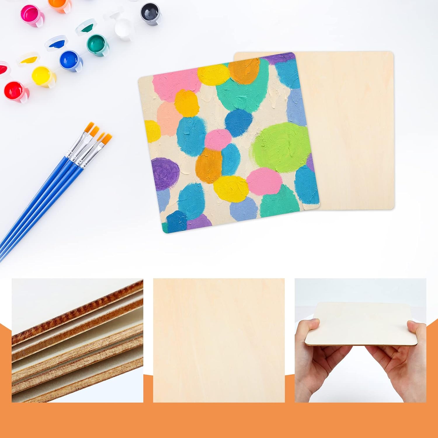 Colorful polka dot notebook with paintbrushes and cardboard sheets on a white background