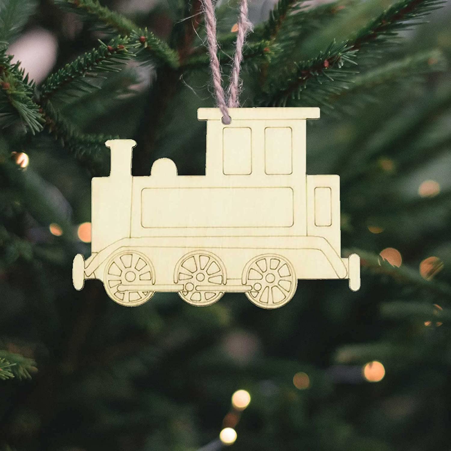 Wooden train ornament hanging on a Christmas tree