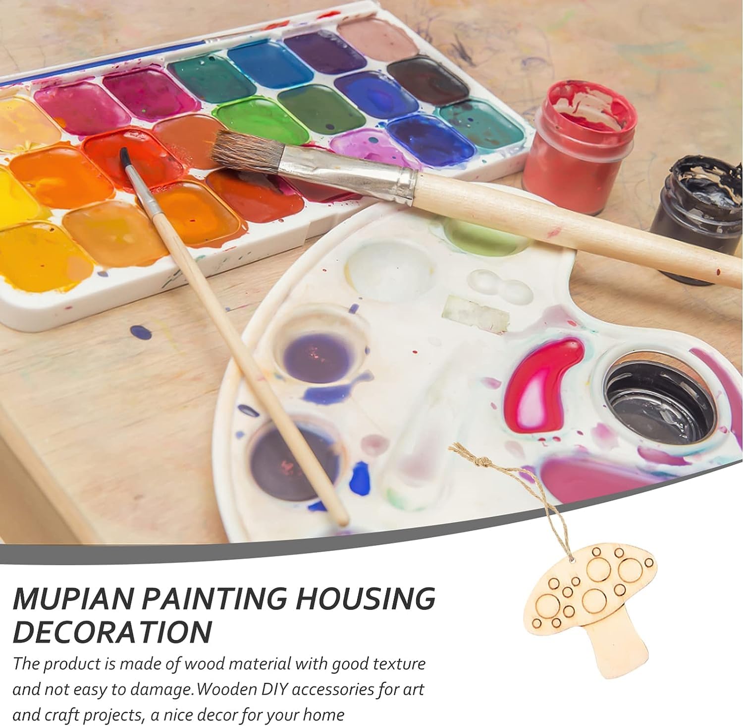 Painting supplies including a paint palette, watercolor paints, and brushes on a wooden surface.