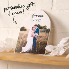 Personalized photo plaque with a couple in a field and 'forever 9:17:22' text, placed on a wooden surface.