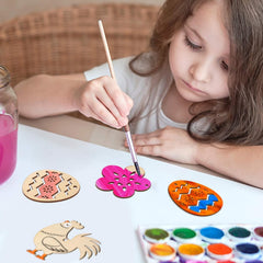 Child painting wooden cutouts with a watercolor palette on a table.