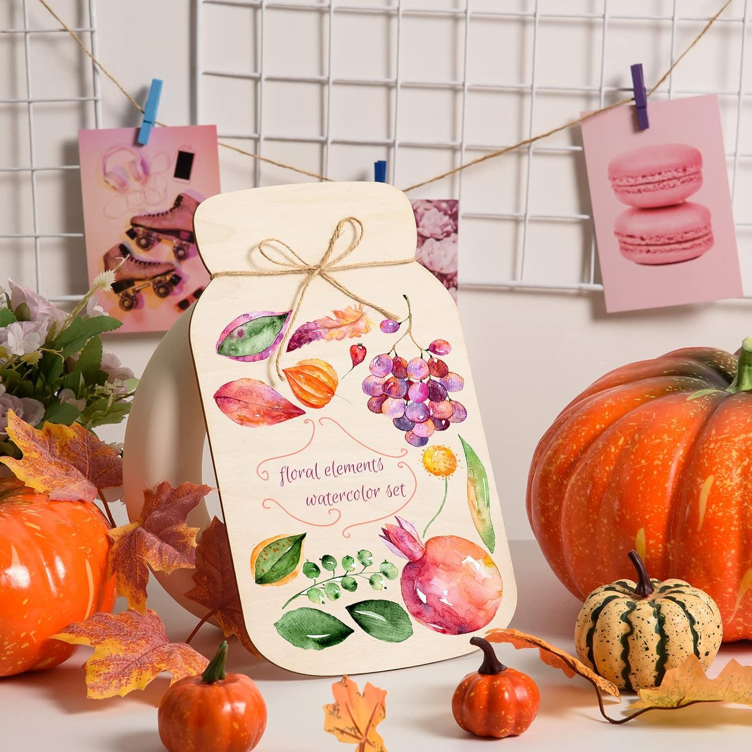 Decorative card with floral elements surrounded by pumpkins and autumn leaves.