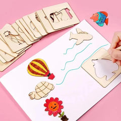 Wooden cutout shapes on a pink background with a hand holding a fish-shaped cutout.