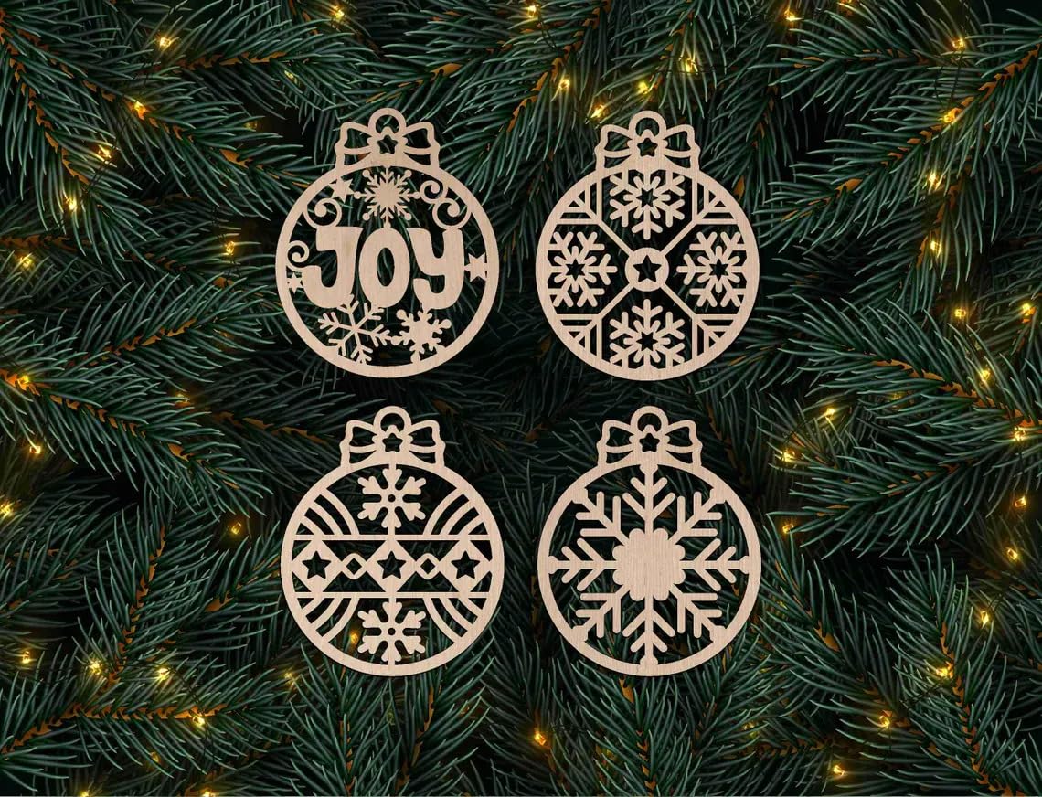 Four decorative Christmas ornaments with snowflake patterns and the word 'JOY' on a green leafy background.
