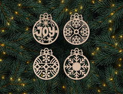 Four decorative Christmas ornaments with snowflake patterns and the word 'JOY' on a green leafy background.