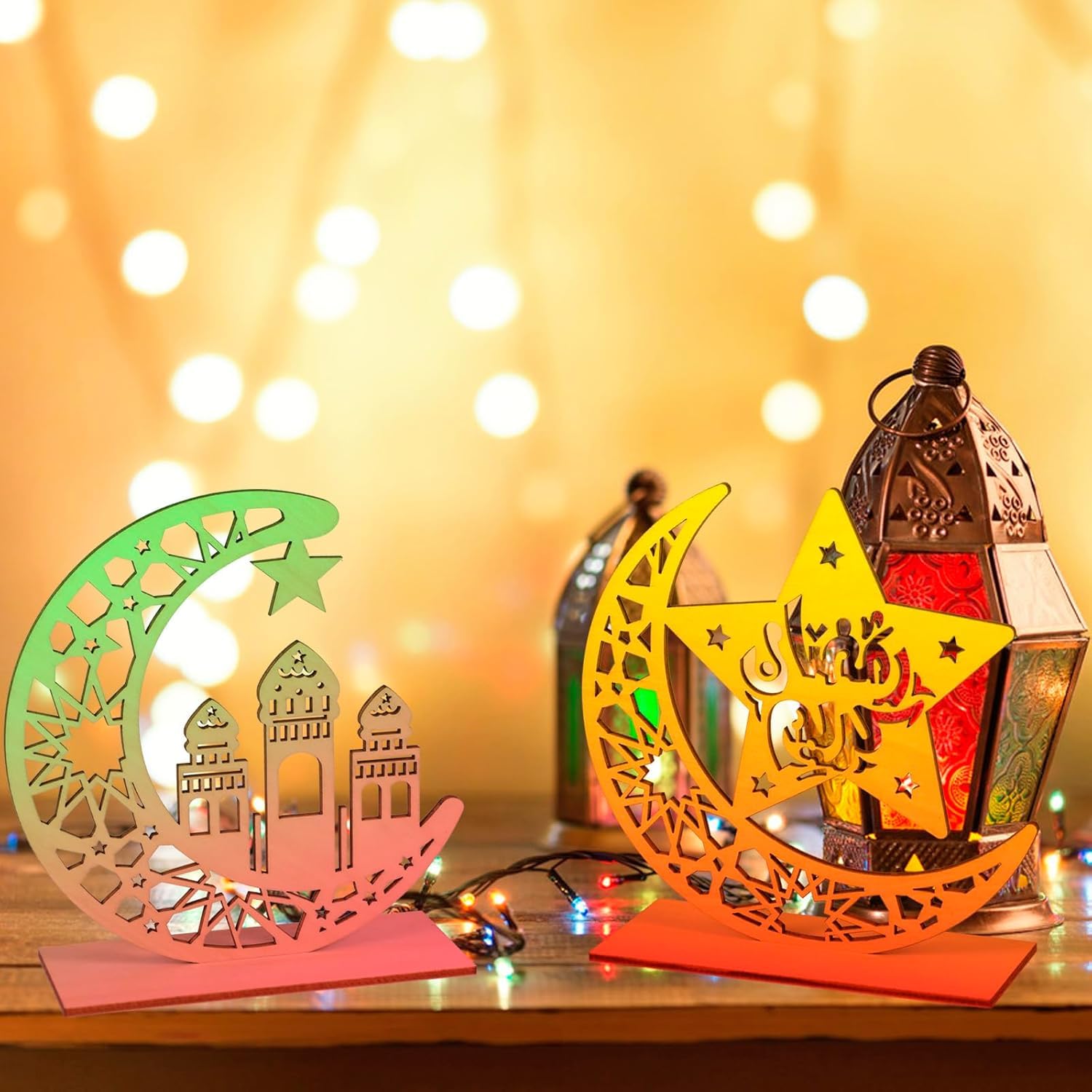 Decorative lanterns shaped like a crescent moon and star with intricate designs on a wooden surface.