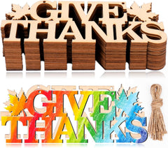 Wooden 'Give Thanks' letters with decorative elements on a white background