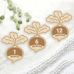 Wooden baby milestone markers with numbers on a white background