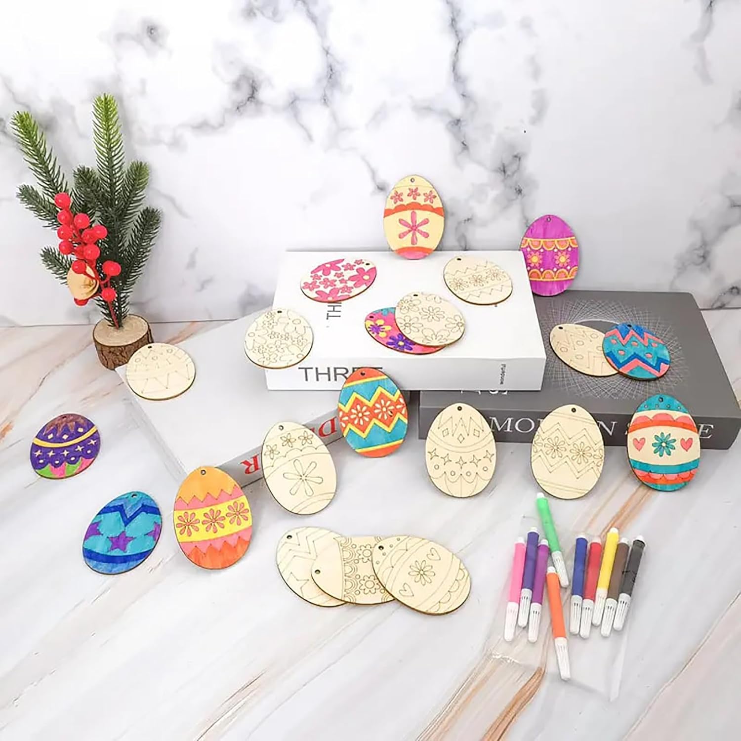 Decorative Easter egg ornaments with markers on a marble surface