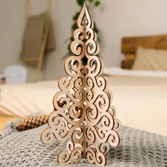 Decorative wooden Christmas tree on a bed with a blurred background