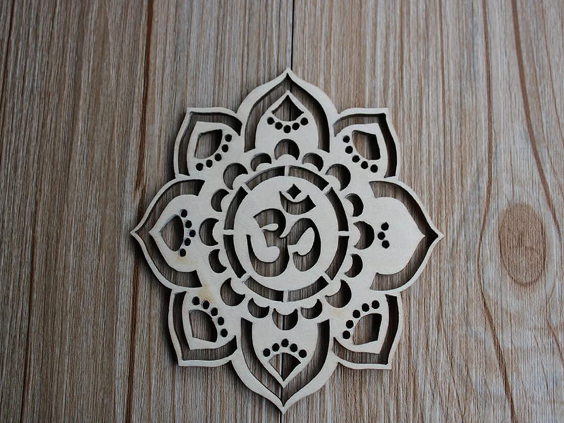 Decorative wooden mandala with Om symbol on a wooden surface