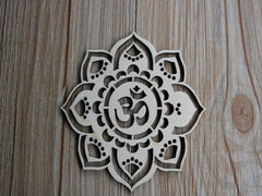 Decorative wooden mandala with Om symbol on a wooden surface
