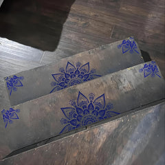 Metal sheets with blue floral patterns on a wooden surface