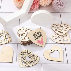 Wooden heart-shaped decorations with cut-out designs on a white surface.