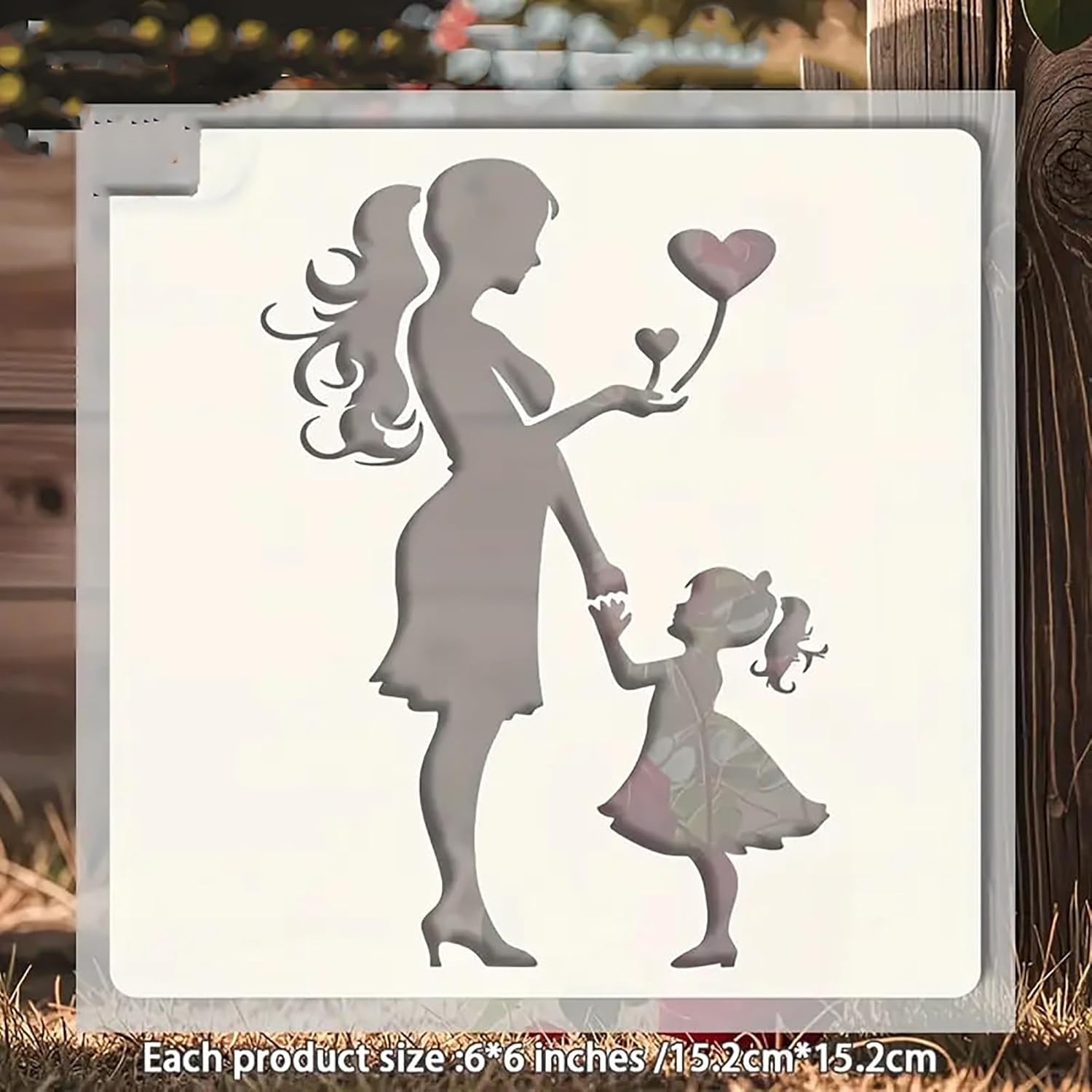 Decorative metal wall art of a woman and child with a heart-shaped balloon on a wooden background.
