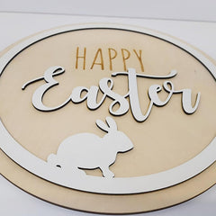 Decorative sign with 'Happy Easter' text and a rabbit silhouette on a beige background.