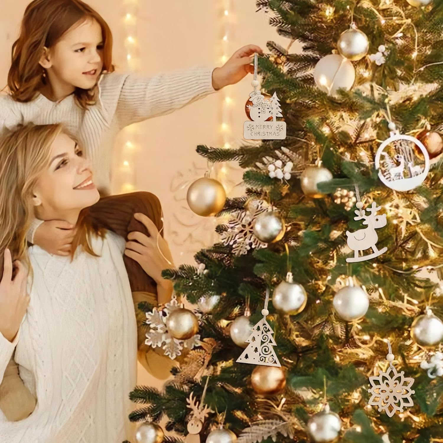 Woman and child decorating a Christmas tree with ornaments.