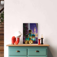 Decorative wall art with colorful lanterns and a castle on a white wall above a teal dresser.