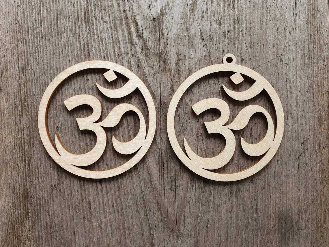 Two wooden om symbol earrings on a wooden background